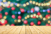 Empty wood table top with blur Christmas tree with bokeh light background Poster #625903320