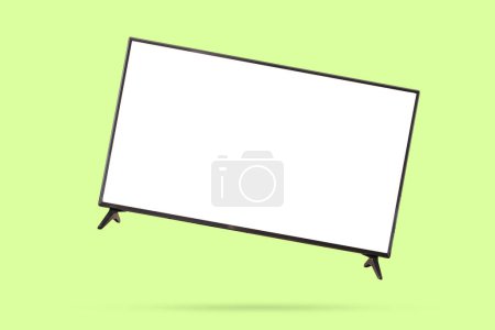 Photo for White screen LED TV television floated on green background - Royalty Free Image