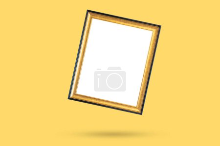 Photo for Blank golden vintage wood picture photo frame isolated on yellow background - Royalty Free Image