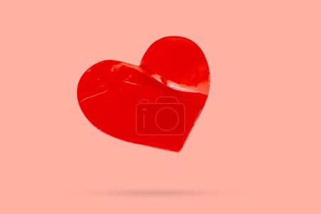 red heart shape sticker isolated on pink background