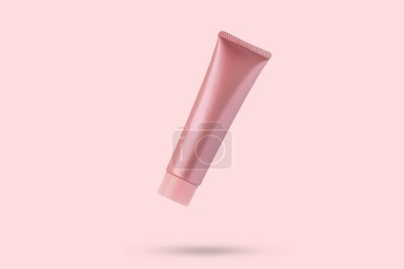 Blank pink cosmetic tube mockup isolated on pink background