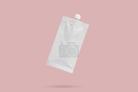 Blank white cosmetic cream sachet with plastic cap isolated on pink background