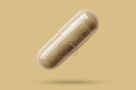 Herbal medicine capsule isolated on brown background