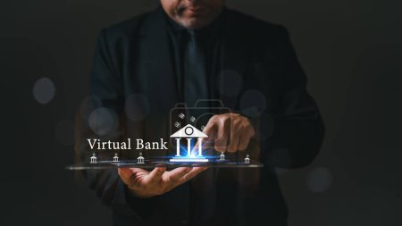 Le directeur bancaire tient une tablette avec un logo de banque virtuelle dessus. Concept de modernité et de progrès technologique