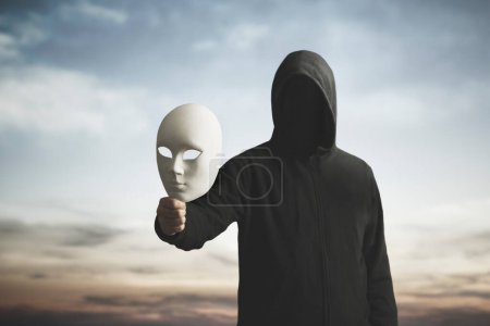 Photo for Surreal image of a man with obscured face showing his mask, concept of playing with the different personalities of one's character - Royalty Free Image