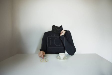 Foto de Headless surreal woman draws a smile emoji on the table with coffee, concept of communicating one's mood - Imagen libre de derechos