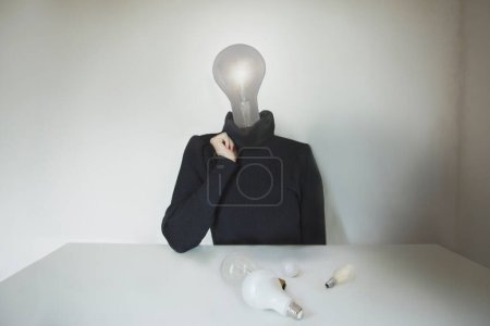 Photo for Surreal person with light bulb instead of head has a doubt about his idea; concept of choice, creativity, doubt; idea, technology - Royalty Free Image