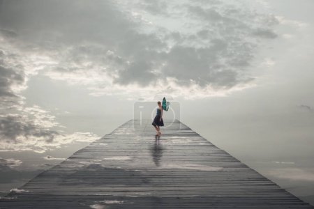 surreal woman with butterfly wings walks free on a jetty leading to the sea, abstract concept