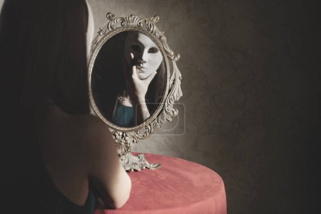 Photo for Reflection of a vain woman with mask in front of the mirror, identity concept - Royalty Free Image