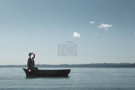 Photo for Lonely man sailing lost in a small boat in the middle of the sea looking for himself - Royalty Free Image