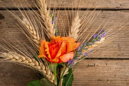 Photo for Rose with wheat and lavender on wooden background - Royalty Free Image