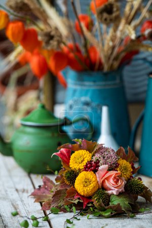 Colorful autumn flowers bouquet on a garden table