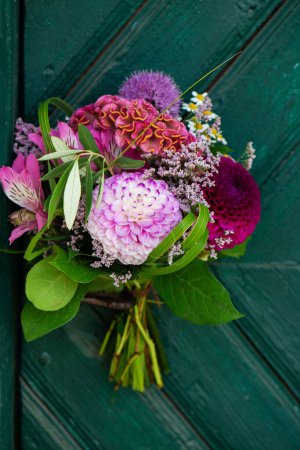 Photo for Colorful flower bouquet on a wooden door with copy space - Royalty Free Image