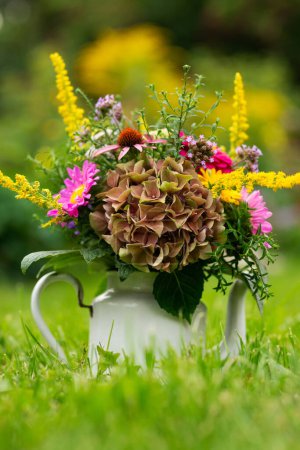Photo for Colorful flower bouquet in a enamel pot in a meadow - Royalty Free Image