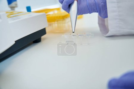 Photo for Llaboratory assistant holds a special pellet in his hand, he measures the biomaterial and fills the containers for analysis - Royalty Free Image