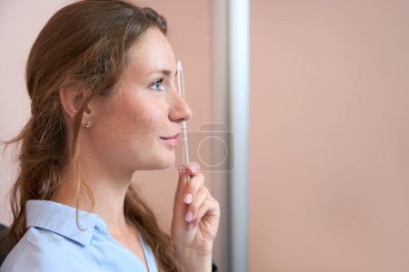 Photo for Close up side view portrait of beautiful Caucasian female is examining her eyesight in the qualified ophthalmology center - Royalty Free Image