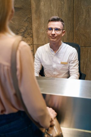 Photo for Cropped vertical photo of the friendly manager of a beauty salon who receives a client - Royalty Free Image