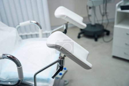 Photo for Cropped photo of the gynecological chair which is located in the doctors office. Gynecological chair in the gynecologist office - Royalty Free Image
