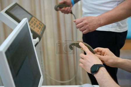Photo for Cropped photo of experienced healthcare professional preparing adult person for BCA in clinic - Royalty Free Image