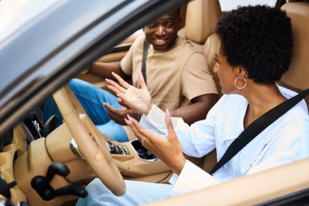 Foto de Pareja afroamericana, hombre y mujer, sentados en un coche moderno, personas con cinturones de seguridad - Imagen libre de derechos