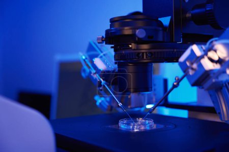 Gros plan de microscope puissant équipé de micromanipulateurs et de microinjecteurs utilisés pour la manipulation cellulaire lors de l'injection intracytoplasmique de sperme