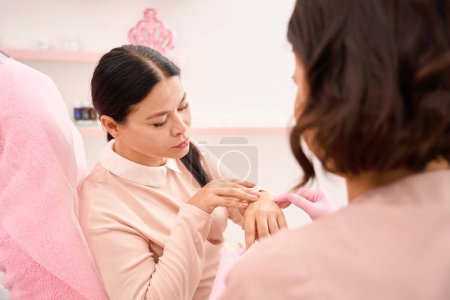Photo for Beautiful woman is having a consultation with a cosmetologist, she is wearing comfortable casual clothes - Royalty Free Image