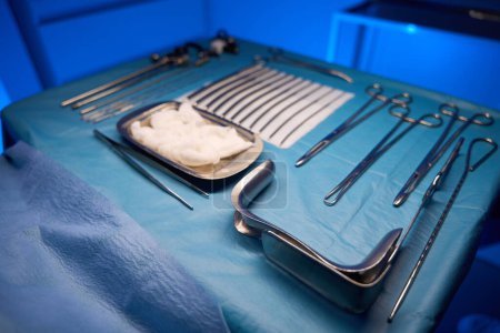 Photo for Set of medical equipment include scalpels and hysteroscope before surgery on table in clinic - Royalty Free Image