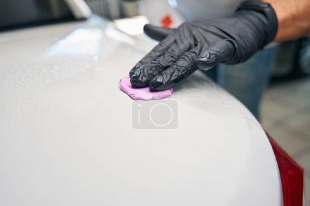 Photo for Process of using special clay in car detailing, a repairman uses a spray gun - Royalty Free Image