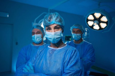 Photo for Medical team after operation in operating room satisfied with positive result of their work - Royalty Free Image