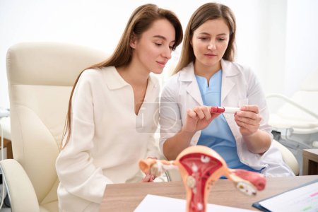 Photo for Focused female caucasian gynecologist and young european woman looking patient test in clinic. Concept of pregnancy and maternity - Royalty Free Image