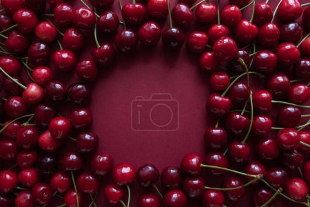 Ripe cherry berries with a space for text in the center. Top view. Food concept.