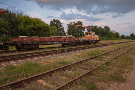 Photo for Stara Vyzhivka, Ukraine - July 12th, 2021: Railway special equipment. Special construction train for maintenance of railway, rail, sleepers. Heavy machinery repairs rail lines. - Royalty Free Image