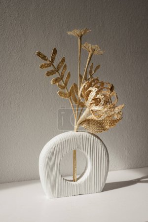 A wooden vase with a bouquet of flowers made from straw. Straw weaving