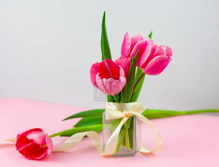 Photo for Bouquet of pink tulips in a vase isolated on a light background - Royalty Free Image