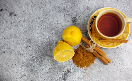 Photo for Drink with lemon and cinnamon sticks on the table. Free space for text - Royalty Free Image