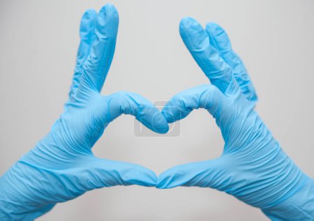 Photo for Doctors hands in medical gloves in heart shape with copy space. - Royalty Free Image