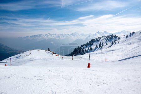 Photo for Ski slope with snowy mountains and valley in winter in Austrian Alps. Blue sky with mountains. - Royalty Free Image