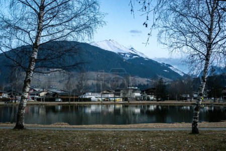Photo for Evening lake with city and snowy mountains in Austria in Alps. - Royalty Free Image