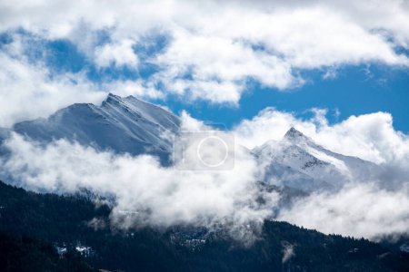 Photo for Pointed peaks of snowy mountains in the clouds in winter in the Austrian Alps. - Royalty Free Image