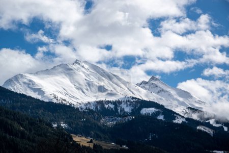 Photo for Mountain range of Austrian Alps, pointed rocks covered with snow above forest and meadow in winter. - Royalty Free Image
