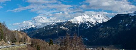 Photo for Panorama of Austrian Alps with snowy peaks and deep valley in early spring. - Royalty Free Image