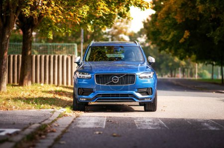 Photo for Blue Volvo XC90 parked on the street illuminated by the autumn sun. - Royalty Free Image