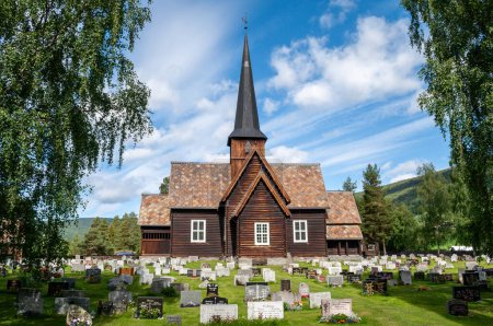 Photo for Old wooden church Heidal in Norway with cemetery with tombstones - Royalty Free Image