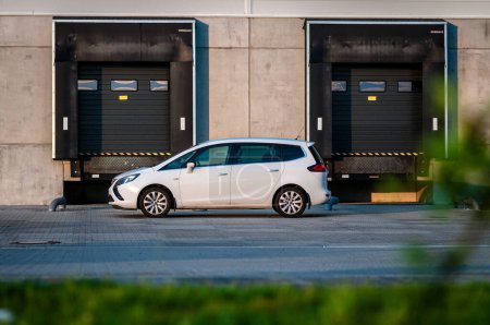 Téléchargez les photos : Brno, République tchèque - 20 mai 2023 : Voiture familiale blanche Opel Zafira Tourer MPV devant les entrepôts d'une zone industrielle. - en image libre de droit