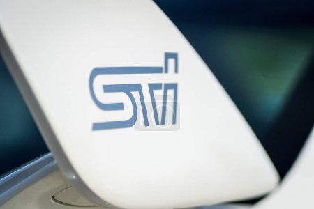 Téléchargez les photos : Brno, Czech Republic - May 16, 2024: White Subaru WRX STI sports car. Detail of the STI logo on the rear sports wing. - en image libre de droit