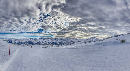 Panoramic image of a ski slope in Ifen ski resort in Kleinwalsertal valley in Austria during the daytime