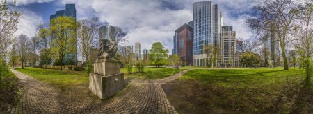 Panoramic picture of the Frankfurt skyline in front of blue sky with light clouds during the day