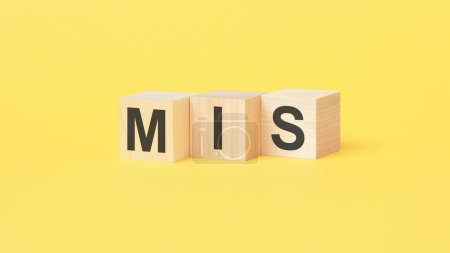 mis - text on wooden cubes, yellow background