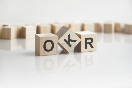 Photo for Text OKR on wooden blocks with letters on a white background - Royalty Free Image