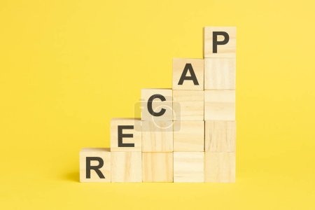 Photo for The word RECAP is written on a wooden cubes pyramide. blocks on a bright yellow background - Royalty Free Image
